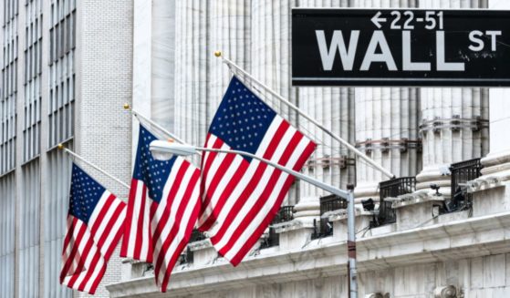 A Wall Street sign is seen in the above stock image.
