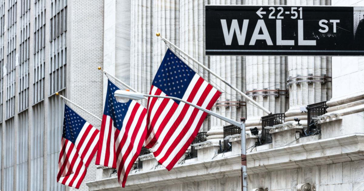 A Wall Street sign is seen in the above stock image.