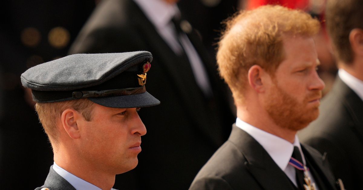 Prince William and Prince Harry follow the coffin of Queen Elizabeth II as it is pulled after her funeral service in Westminster Abbey, in central London Monday.