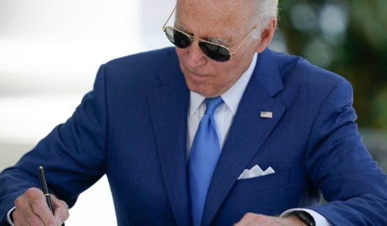 President Joe Biden signs two bills aimed at combating fraud in the COVID-19 small business relief programs at the White House on Aug. 5 in Washington, D.C.