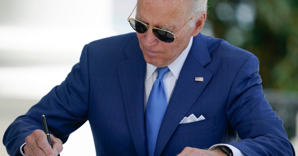 President Joe Biden signs two bills aimed at combating fraud in the COVID-19 small business relief programs at the White House on Aug. 5 in Washington, D.C.