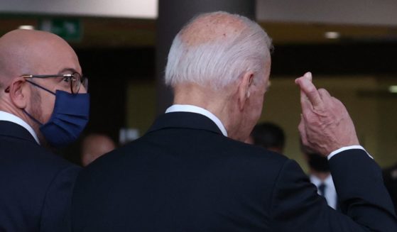 President Joe Biden crosses his fingers as he answers journalists about the Boeing-Airbus trade dispute deal on June 15, 2021.