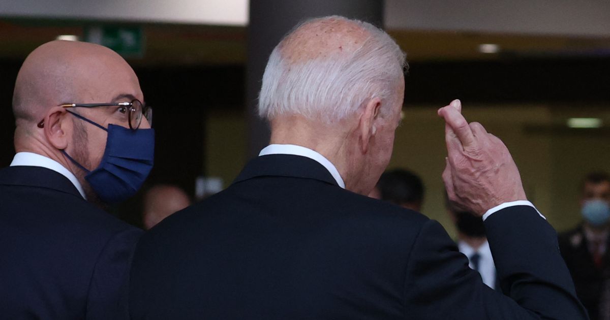 President Joe Biden crosses his fingers as he answers journalists about the Boeing-Airbus trade dispute deal on June 15, 2021.