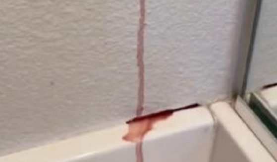 A still from a video of a woman's wall "bleeding."
