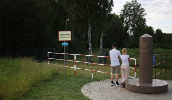 People visit the area marking the place where borders of Poland, Lithuania and Russia's Kaliningrad Oblast meet, in Zerdziny, Poland, on July 7.