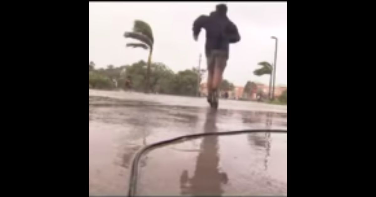 Cameraman Glen Ellis dropped his camera in the middle of a live report on Hurricane Ian to help a family get through the flood waters.