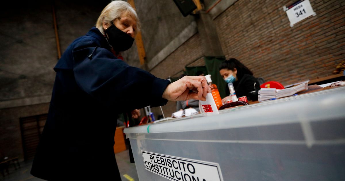 A woman casts her vote in on a new draft of the Constitution in Santiago, Chile, on Sunday.