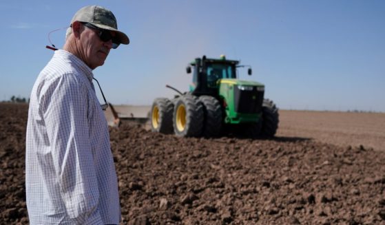 Farmer Larry Cox watching a tractor at work