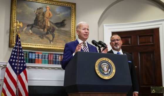 U.S. President Joe Biden, joined by Education Secretary Miguel Cardona, speaks on student loan debt in the Roosevelt Room of the White House in a file photo from August.