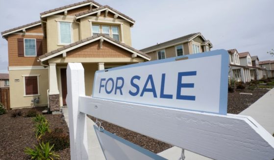 A for sale sign is posted in front of a home in Sacramento, California, on March 3.