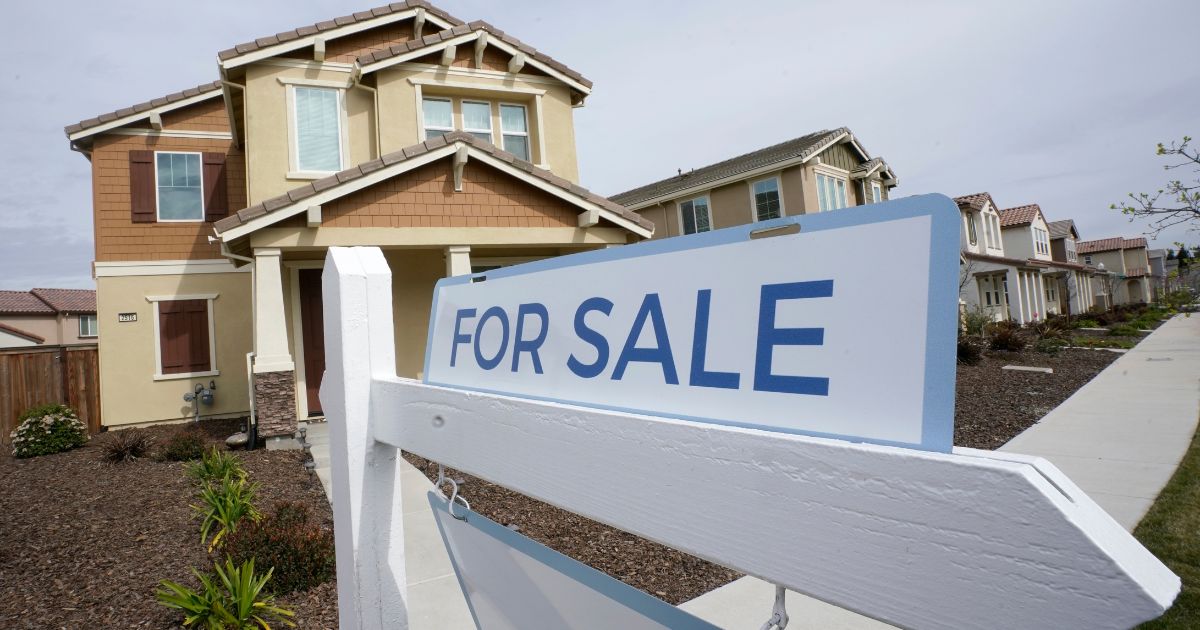 A for sale sign is posted in front of a home in Sacramento, California, on March 3.