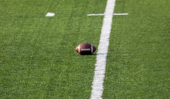 football sitting in the middle of an empty field