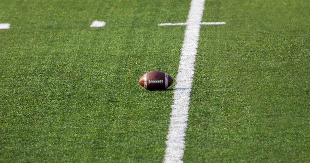 football sitting in the middle of an empty field