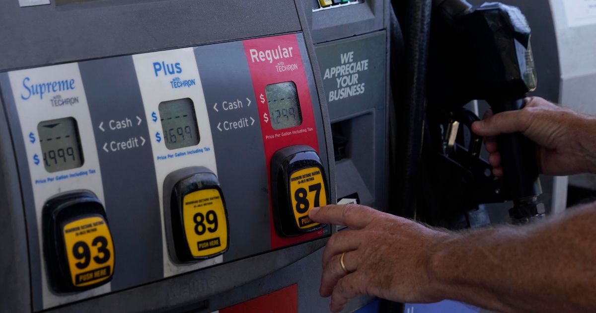 a customer pumping gas at an Exxon gas station