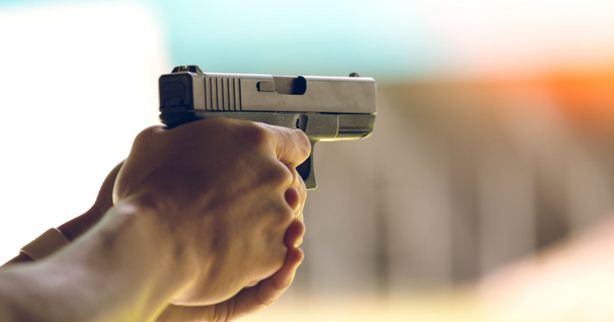 The above stock image is of someone shooting a pistol.