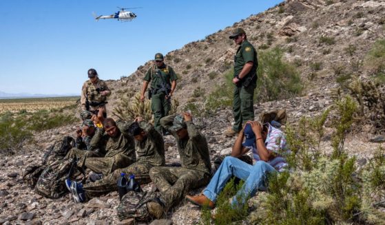 Customs and Border Protection agents detain a group of illegal immigrants on Wednesday at the Organ Pipe National Monument, Arizona.