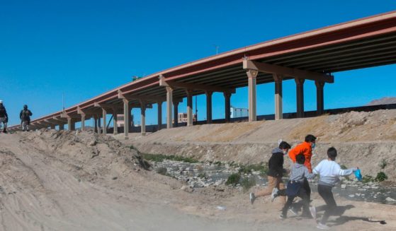 Migrants cross the Rio Bravo to get to El Paso, Texas, from Ciudad Juarez, Mexico, on Feb. 5, 2021.