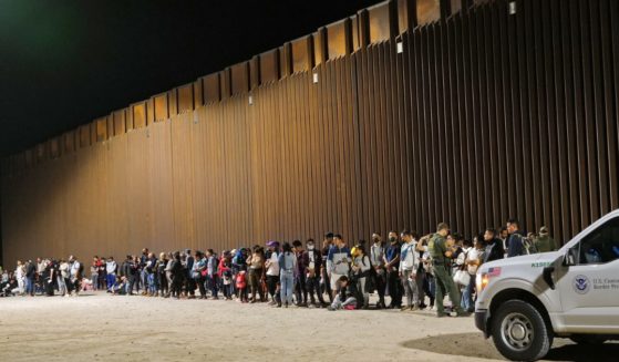 Migrants attempting to cross into the U.S. from Mexico are detained by U.S. Customs and Border Protection at the border Aug. 20 in San Luis, Arizona.