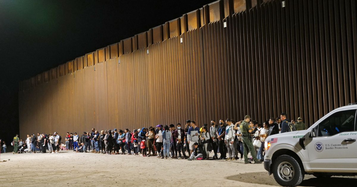 Migrants attempting to cross into the U.S. from Mexico are detained by U.S. Customs and Border Protection at the border Aug. 20 in San Luis, Arizona.
