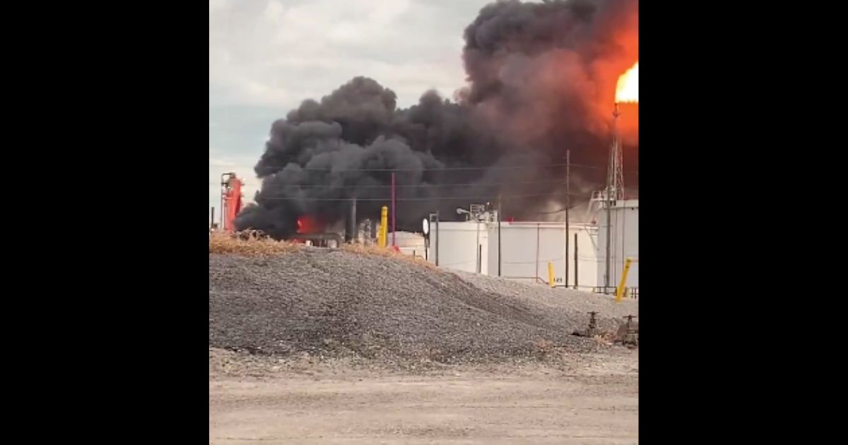 A fiery blast tore through an oil refinery near Toledo, Ohio, on Tuesday, leaving two dead.