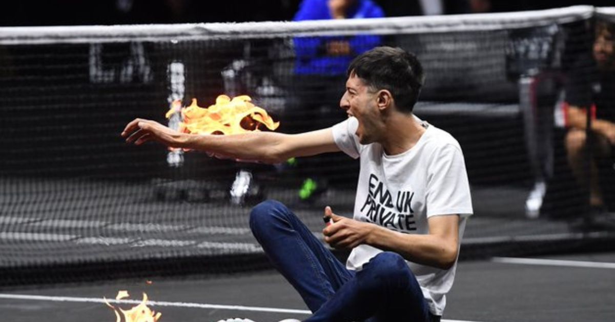 A climate change activist set his arm on fire after rushing the court during a Laver Cup tennis match in London on Friday.
