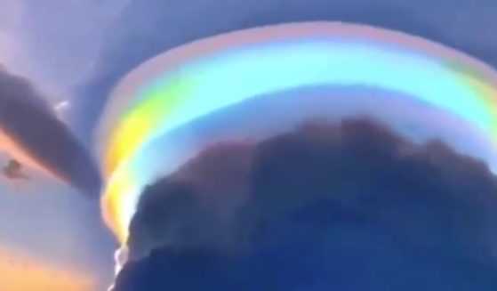 A city in southern China was the scene of a once-in-a-lifetime view as a vibrant, rainbow-colored pileus cloud formed in the sky.