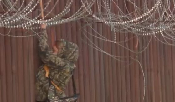 In a scene recorded by Fox News, an illegal alien uses a rope to scale down the side of a border fence in Arizona.