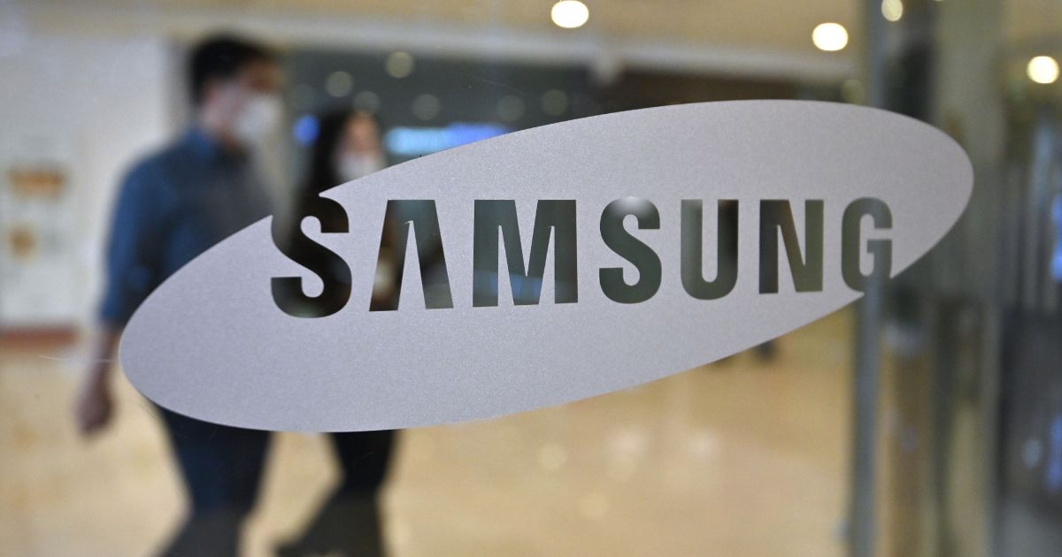People walk past the Samsung logo at the company's showroom in Seoul on Oct. 29, 2020.