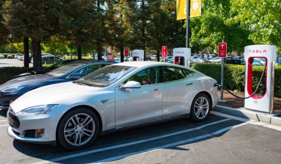 Tesla automobiles plugged in and charging at a Supercharger rapid battery charging station for the electric vehicle company Tesla Motors, in the Silicon Valley town of Mountain View, California, Aug. 24, 2016.
