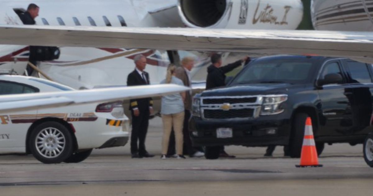 Former President Donald Trump exits a plane near Washington, D.C., on Sunday.