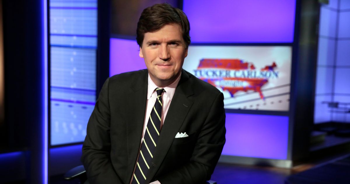 In this March 2, 2017, file photo, Tucker Carlson, host of "Tucker Carlson Tonight," poses for photos in a Fox News Channel studio in New York.