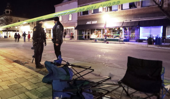 Police stand on W. Main Street in downtown Waukesha, Wisconsin, after an SUV drove through a Christmas parade on Nov. 21, 2021.