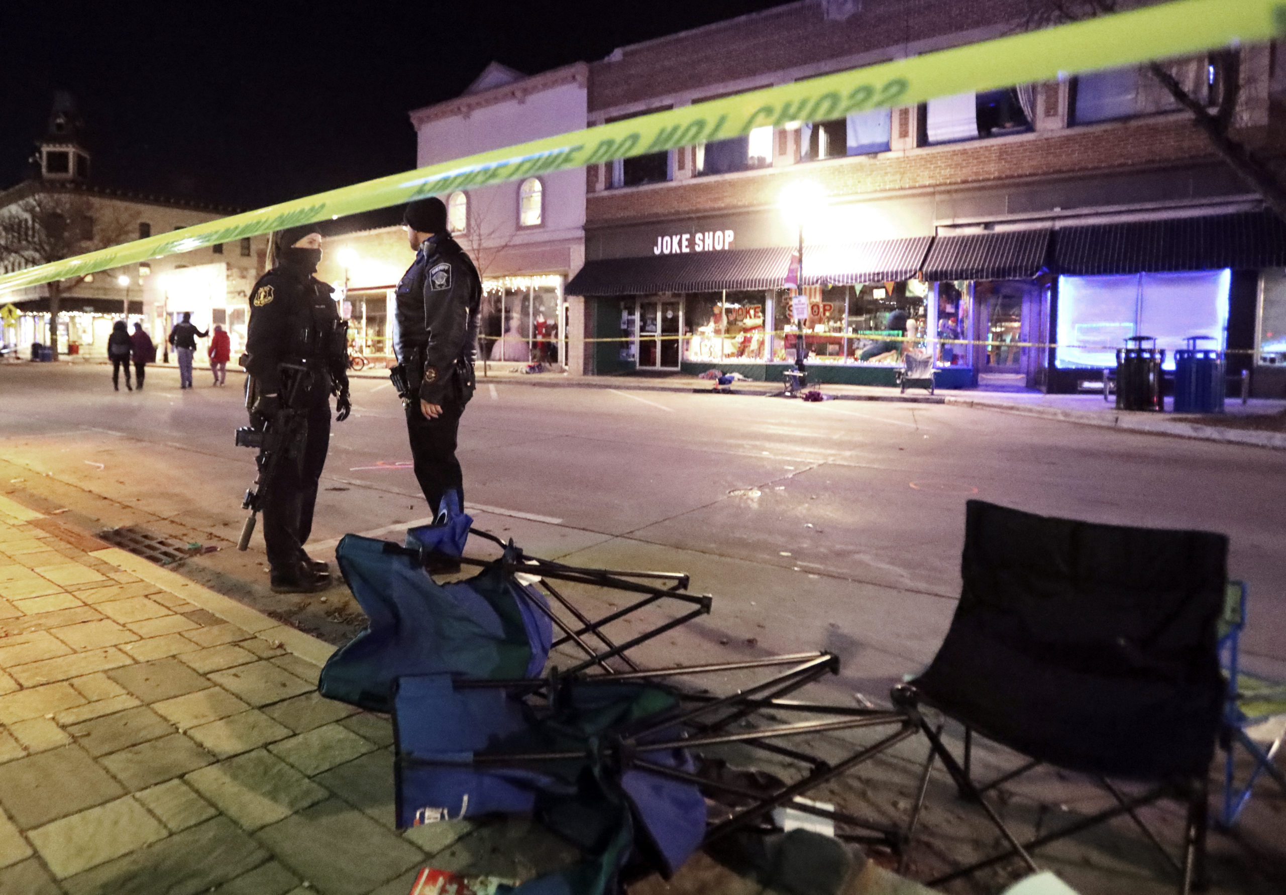 Police stand on W. Main Street in downtown Waukesha, Wisconsin, after an SUV drove through a Christmas parade on Nov. 21, 2021.