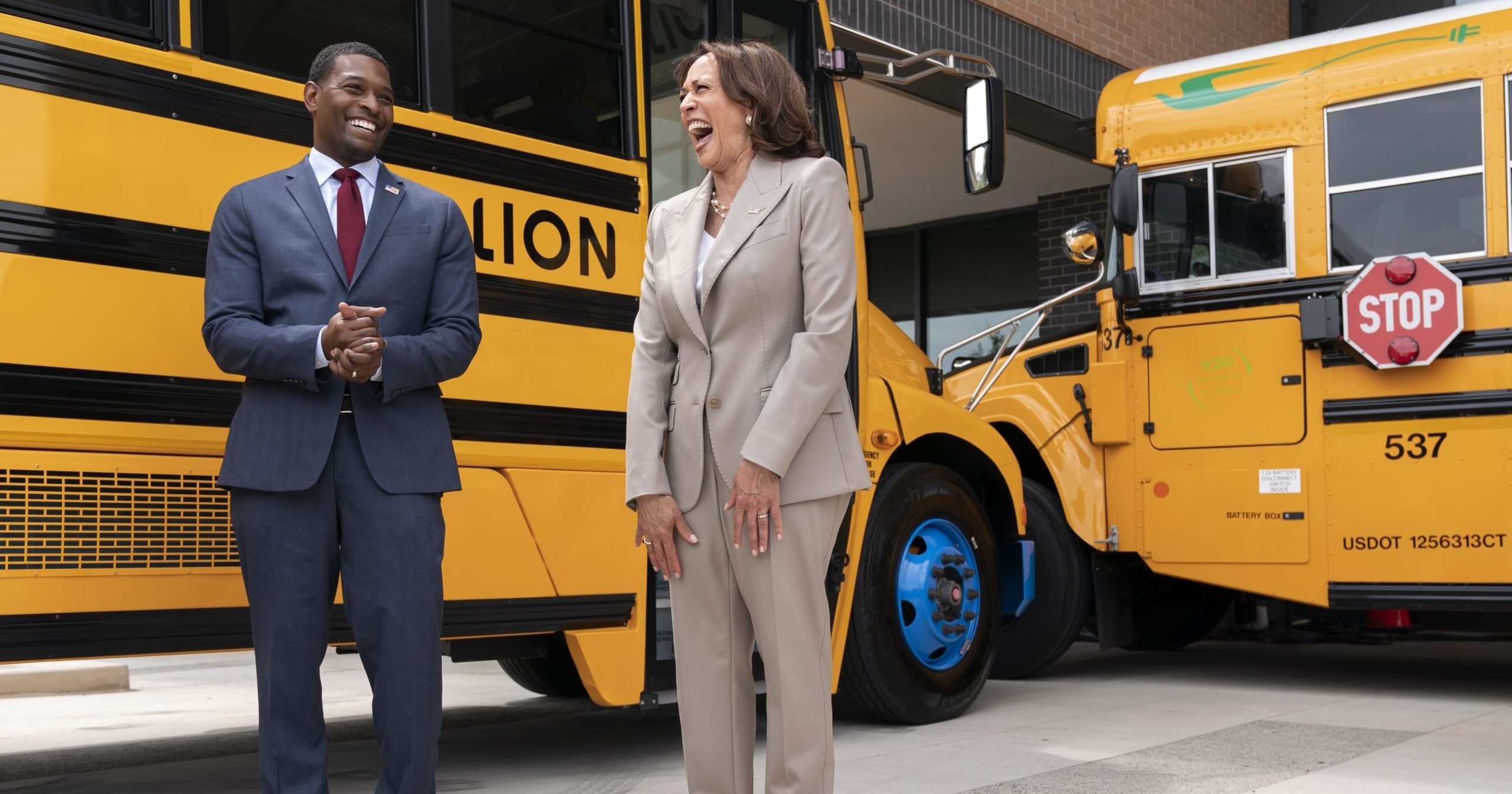 Vice President Kamala Harris laughs with Environmental Protection Agency Administrator Michael Regan during a tour of electric school buses at Meridian High School in Falls Church, Virginia, on May 20.