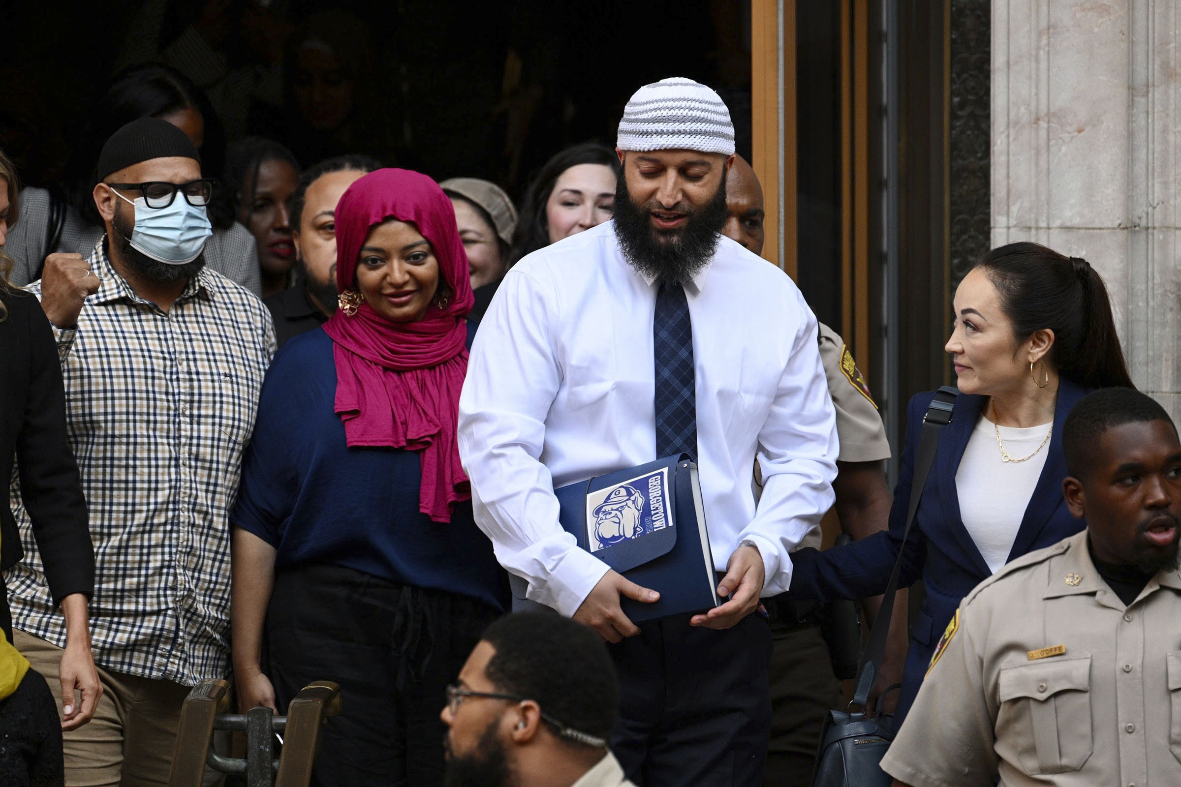 Adnan Syed, center right, leaves the courthouse after a hearing on Sept. 19, 2022, in Baltimore, Maryland.
