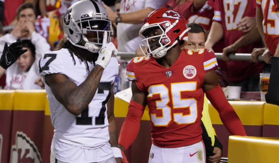 Davante Adams, left, celebrates scoring a touchdown against Jaylen Watson, right, on Monday night during the NFL Monday Night Football Game where the Las Vegas Raiders played the Kansas City Chiefs.