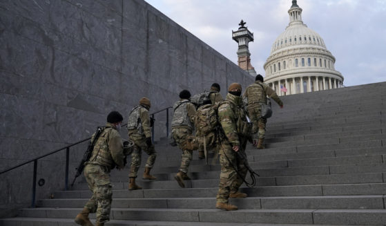 National Guard members take a staircase toward the U.S. Capitol building before a rehearsal for President-elect Joe Biden's inauguration in Washington, D.C., on Jan. 18, 2021.