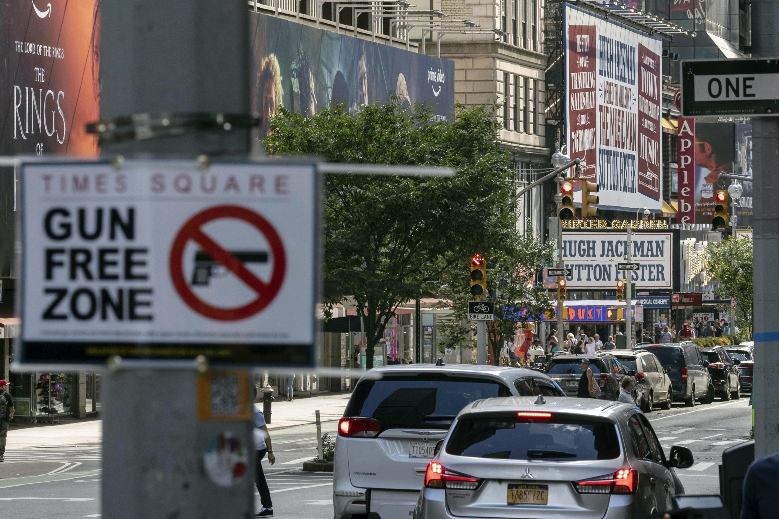 A "Gun Free Zone" sign is posted near New York City's Times Square in this file photo from August. A federal judge said Thursday that New York gun rules which dramatically restrict where people can carry weapons and require concealed carry permit applicants to hand over social media information should be put on hold.