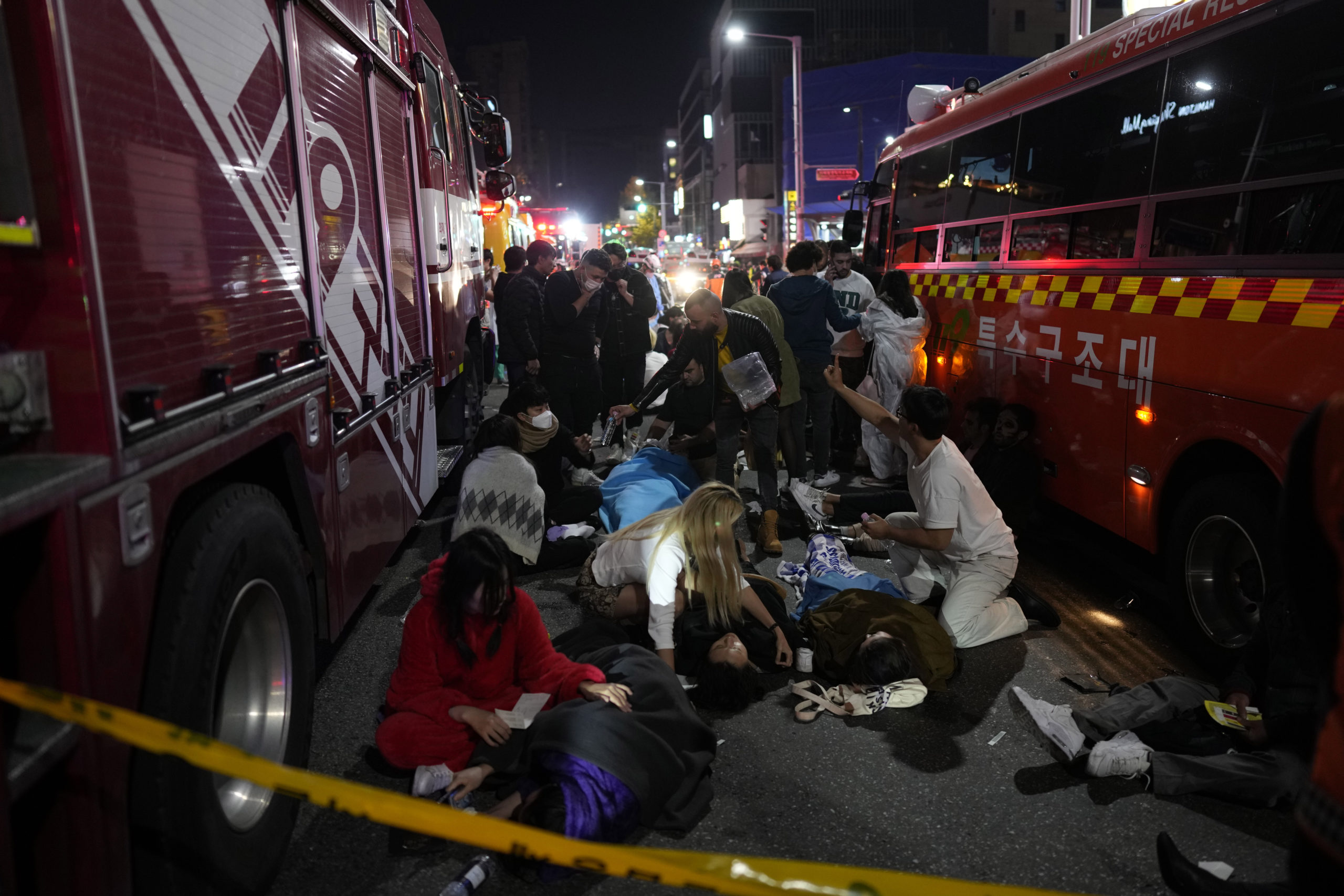 First responders and others attempt to help those who are injured after a crowd surge in Seoul, South Korea, on Saturday led to those attending the Halloween party to be crushed.