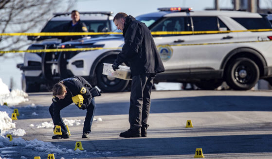 Police investigate a fatal shooting outside of East High School in Des Moines, Iowa, on March 7.
