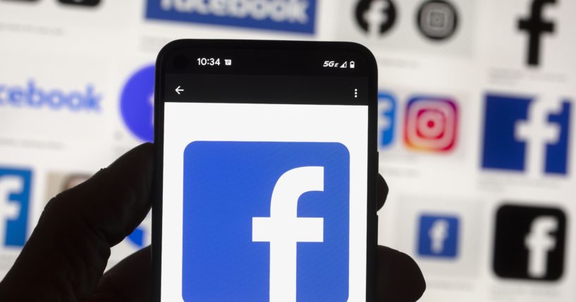 The Facebook logo is seen on a cellphone this month in Boston. A Washington state judge on Wednesday fined Facebook parent company Meta nearly $25 million.