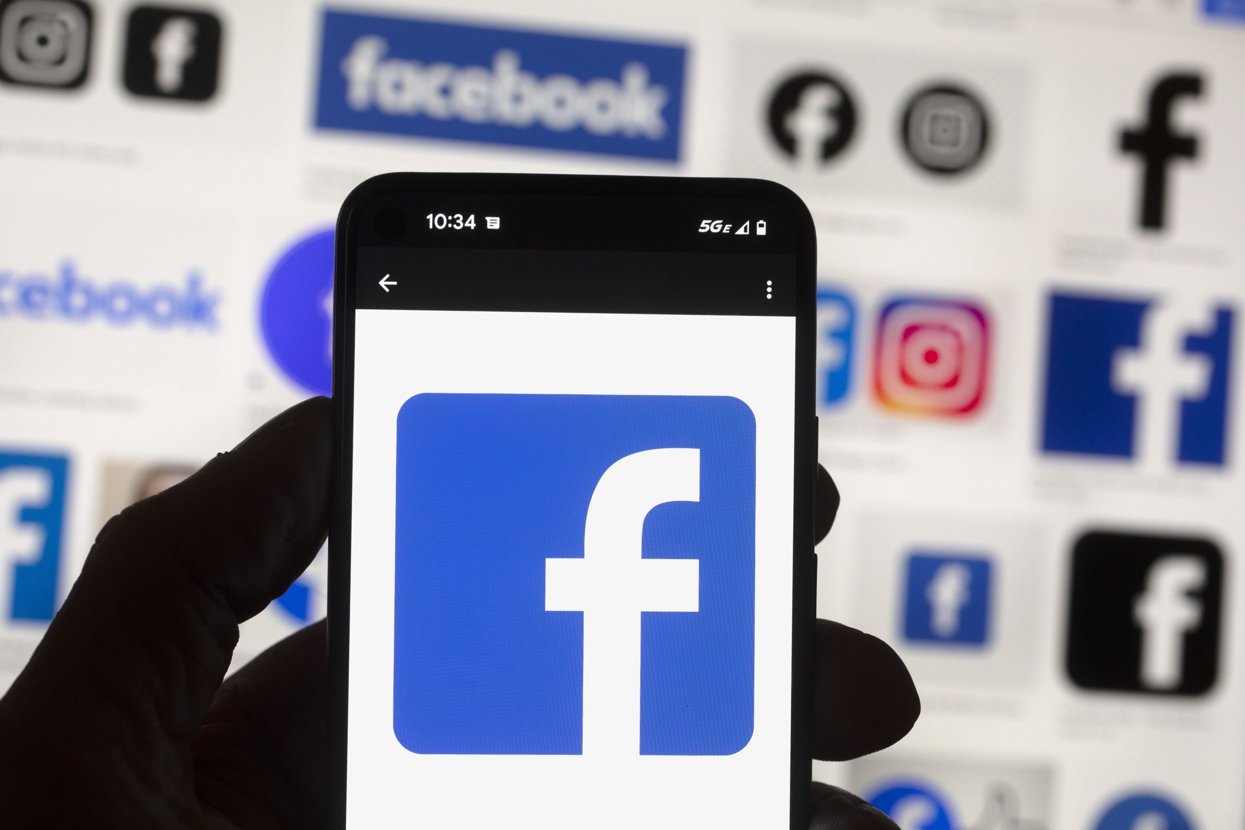 The Facebook logo is seen on a cellphone this month in Boston. A Washington state judge on Wednesday fined Facebook parent company Meta nearly $25 million.