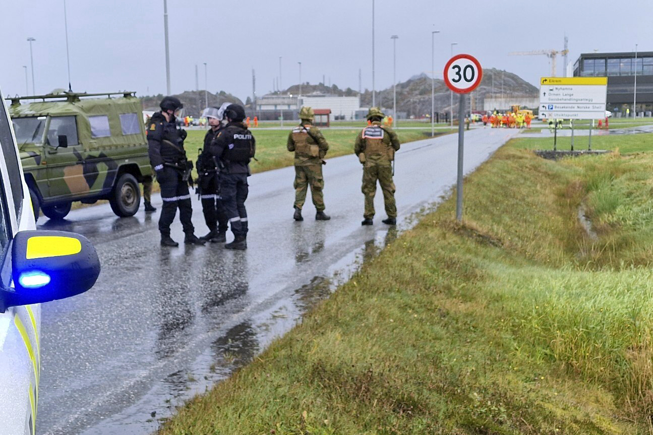 Police and personnel from the Home Guard stand guard outside the land plant of the Ormen Lange gas field after a person called in a bomb threat against the plant in Aukra, Norway, on Thursday.