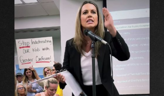 A Twitter post shows Brittany Mayer angrily confronting the Encinitas Union School Board for sending out the invitation to an event sponsored by a gay bar and a gender transition clinic.