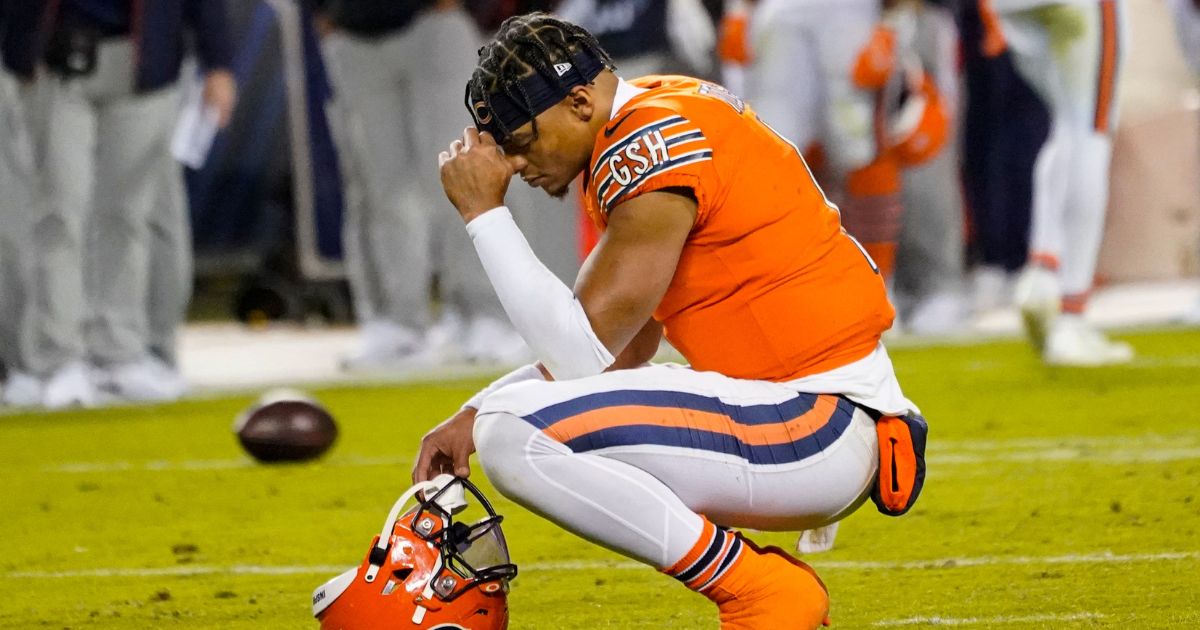 Chicago Bears quarterback Justin Fields kneeling on the field after falling to score
