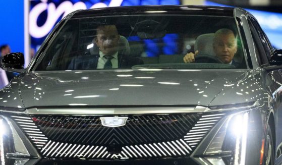 President Joe Biden drives a Cadillac LYRIQ electric vehicle as he tours the Detroit Auto Show on September 14.