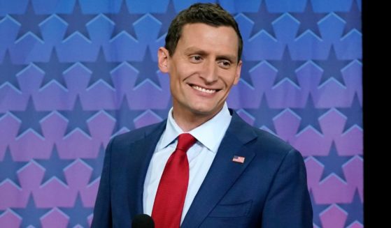 Republican Senate challenger Blake Masters smiles on stage prior to a televised debate with Arizona Democratic Sen. Mark Kelly and Libertarian candidate Marc Victor in Phoenix, Thursday.