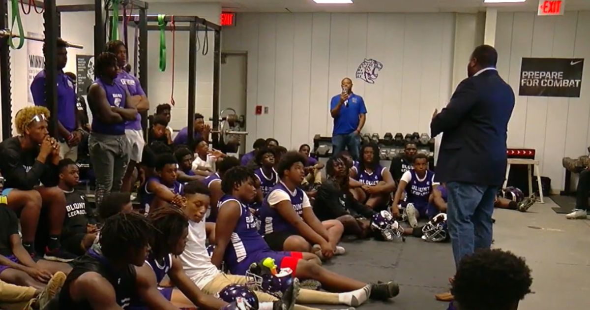 The football team for Mattie T. Blount High School in Mobile, Alabama, gathers for a pep talk.