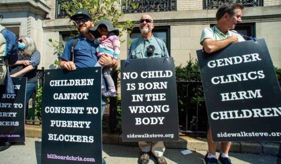 Protesters stand outside of Boston Children's Hospital in Boston, Massachusetts, to voice their concern over "gender affirmation" treatments and surgeries on minors on Sept. 18.