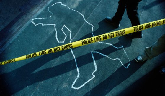 This stock photo shows a chalk outline at a police crime scene.